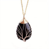 Collier Arbre de Vie en Pierres Naturelles – Pendentif noir et or sur fond blanc